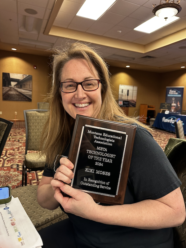 Image of Mrs Moses holding META Award